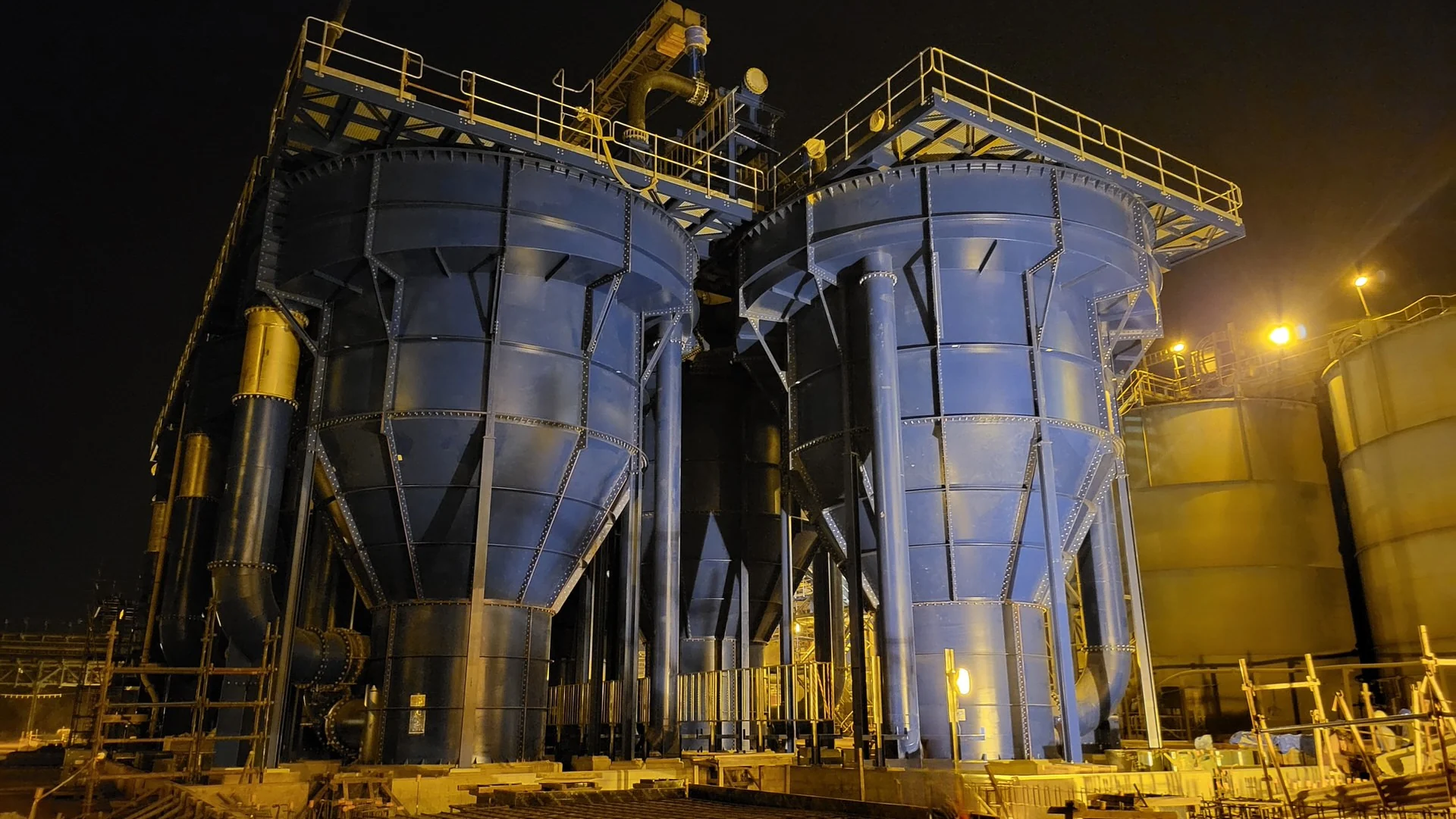 AZTEC UpFlow Reactor vessels installed at a processing plant, photographed at night